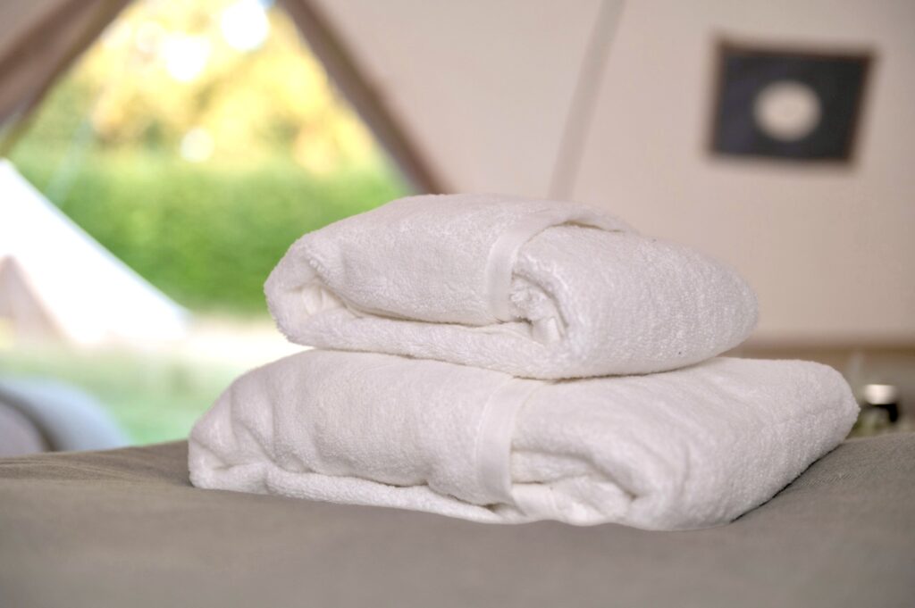 Interior of a bell tent / glamping tent showing Towels on bed